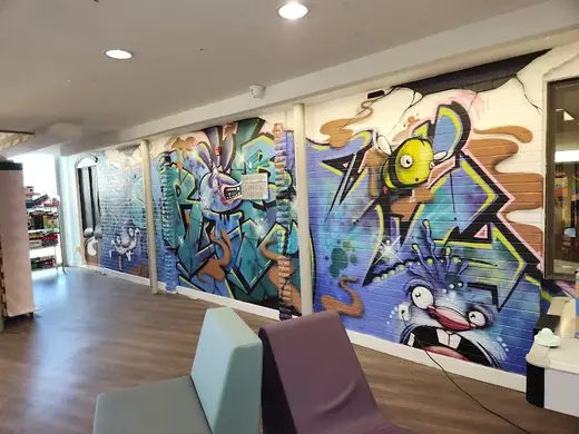 Vibrant graffiti mural in a common area at Synergy Services Program Services detox center in Kansas.