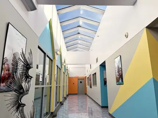 Brightly lit hallway with skylights at KVC Missouri Niles Residential & Academy, a detox center in Kansas.