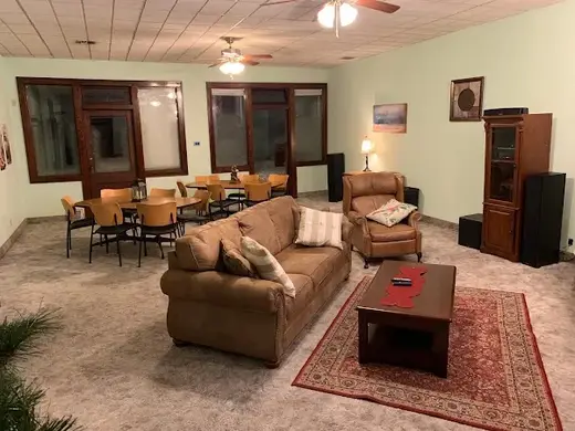 Spacious common area with seating at Sober Living University, a sober living home in Kansas.